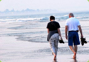couple walking on beach - plan your retirement